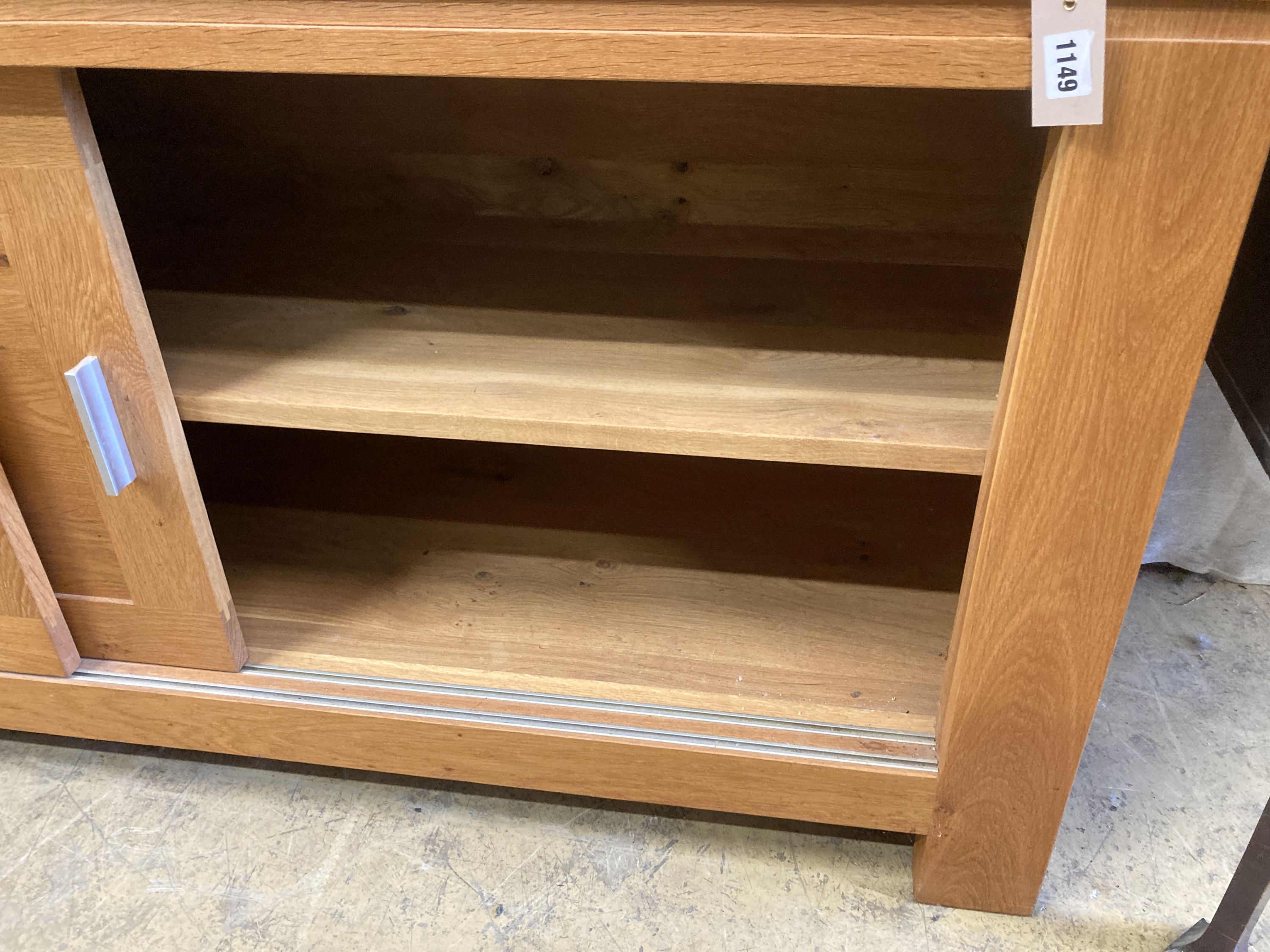 A contemporary light oak sliding door sideboard, length 178cm, depth 50cm, height 78cm